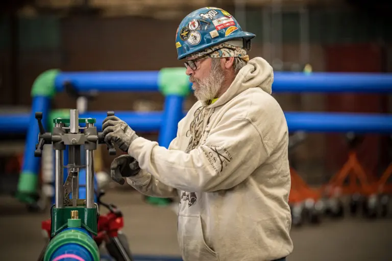 Worker Operating Industrial Machine