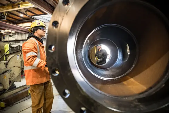 Industrial Worker and Pipe Inspection