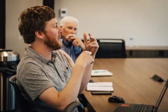 Man Gesturing in Meeting